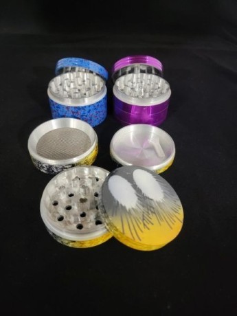 extra-large-herb-grinder-with-kief-catcher-assorted-design-big-0